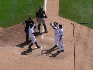 Adam Everett and Ramon Santiago congratulate Curtis Granderson